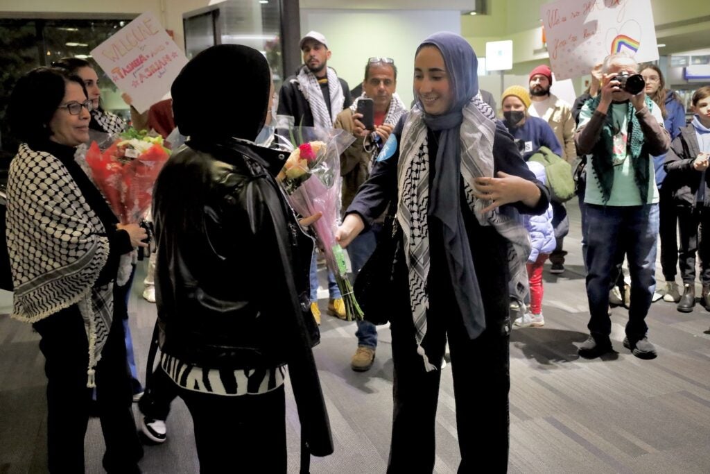 Woman greets Abbas with flowers