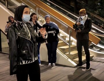 Tasneem Abbas waving to people after arriving at the airport