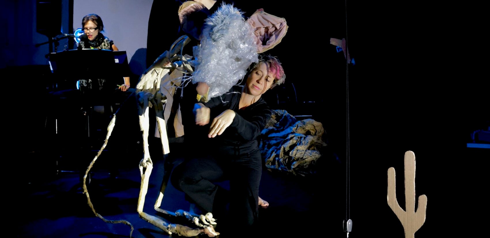 Dancers bring a skeletal packrat to life