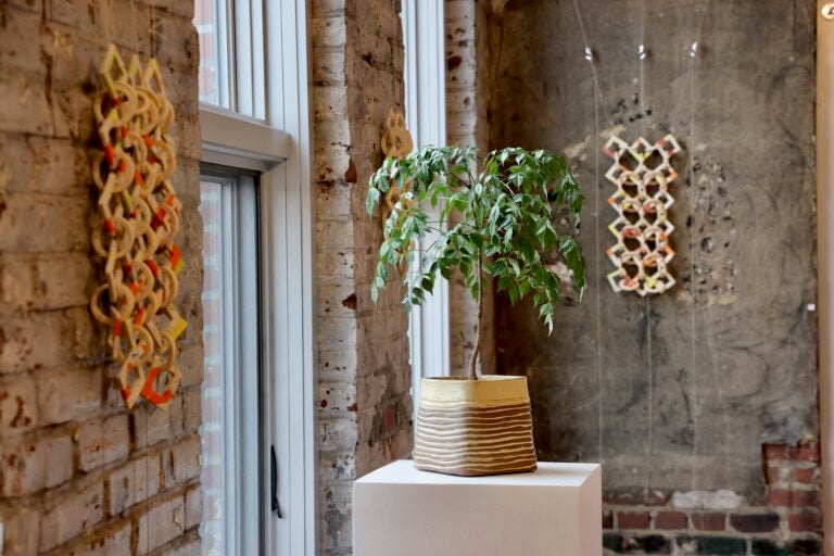 Hazami Sayed's clay works include vessel's and wall hangings. They comprise the one of four parts of her exhibit at Al-Bustan, ''Imprints of Heritage, Links of Community.'' (Emma Lee/WHYY)