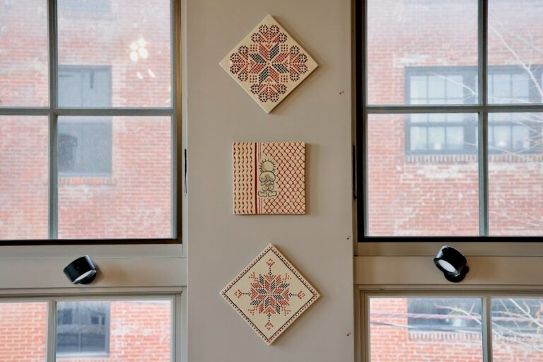 Hazami Sayed's clay tiles are decorated with traditional Palestinian embroidery patterns. (Emma Lee/WHYY)