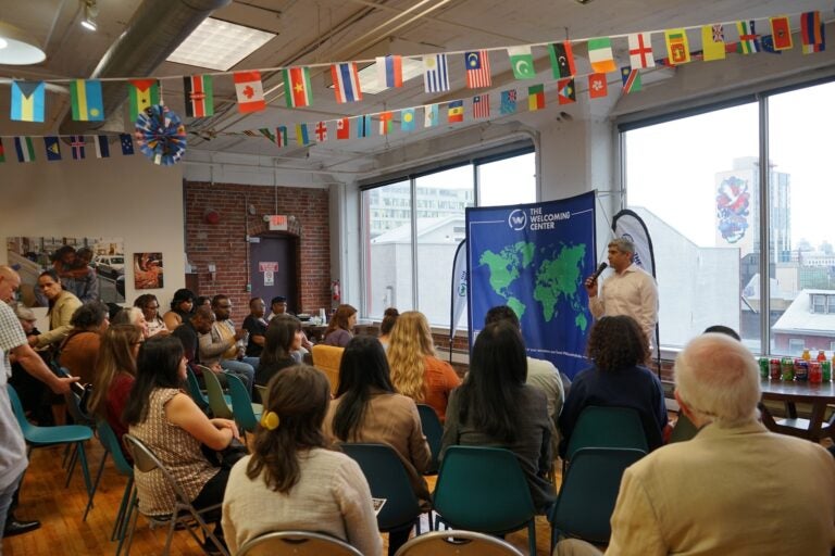 Anuj Gupta, CEO of The Welcoming Center, speaks to a group of people at the center's office in Philadelphia. (Courtesy of The Welcoming Center)