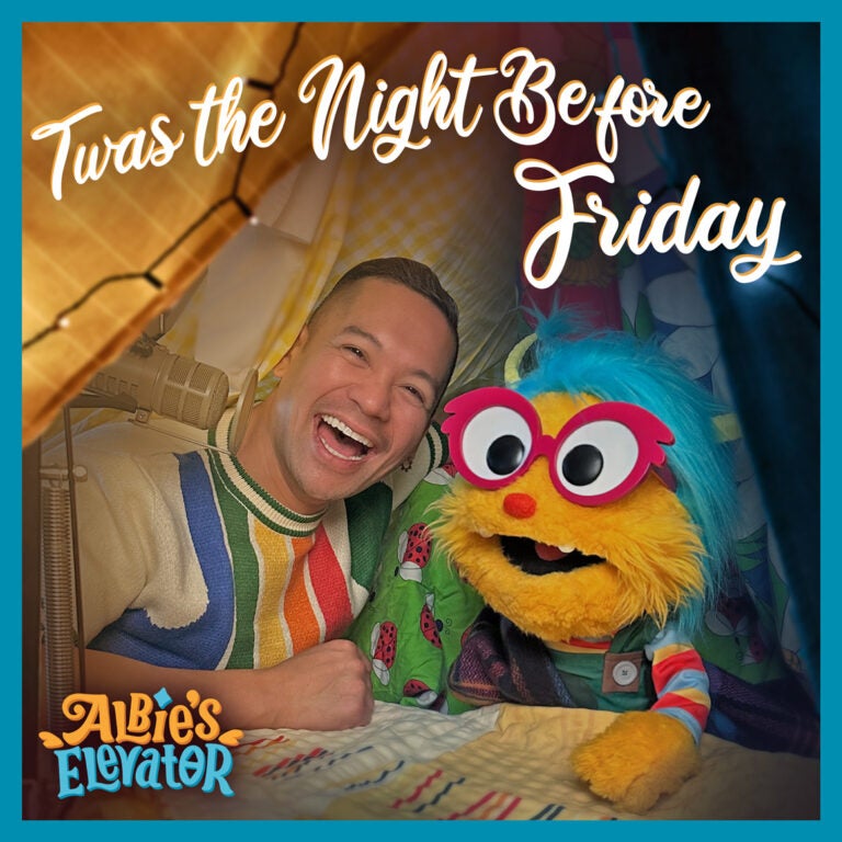 Image of a smiling person in a colorful sweater next to a vibrant yellow puppet with bright blue hair, red glasses, and a cheerful expression. The text 'Twas the Night Before Friday' is displayed in a whimsical font at the top, with the logo 'Albie's Elevator' in the corner.