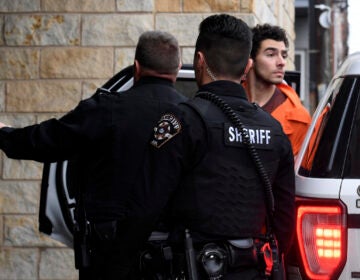 Luigi Nicholas Mangione is escorted into Blair County Courthouse, Tuesday, Dec. 10, 2024, in Hollidaysburg, Pa. (AP Photo/Gary M. Baranec)