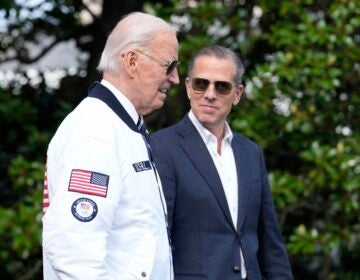 FILE - President Joe Biden, wearing a Team USA jacket and walking with his son Hunter Biden, heads toward Marine One on the South Lawn of the White House in Washington, July 26, 2024. (AP Photo/Susan Walsh, File)