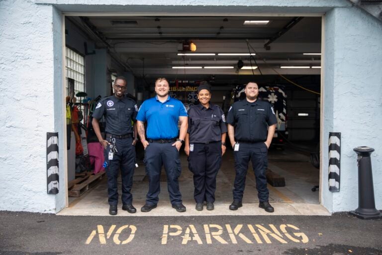 A group photo of 4 EMTS posing at their station