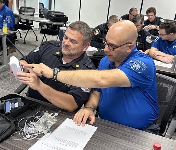 EMTs receiving hands on training in a classroom