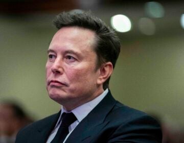 Elon Musk listens as President-elect Donald Trump speaks during a meeting with the House GOP conference, Wednesday, Nov. 13, 2024, in Washington. (Allison Robbert/Pool via AP)