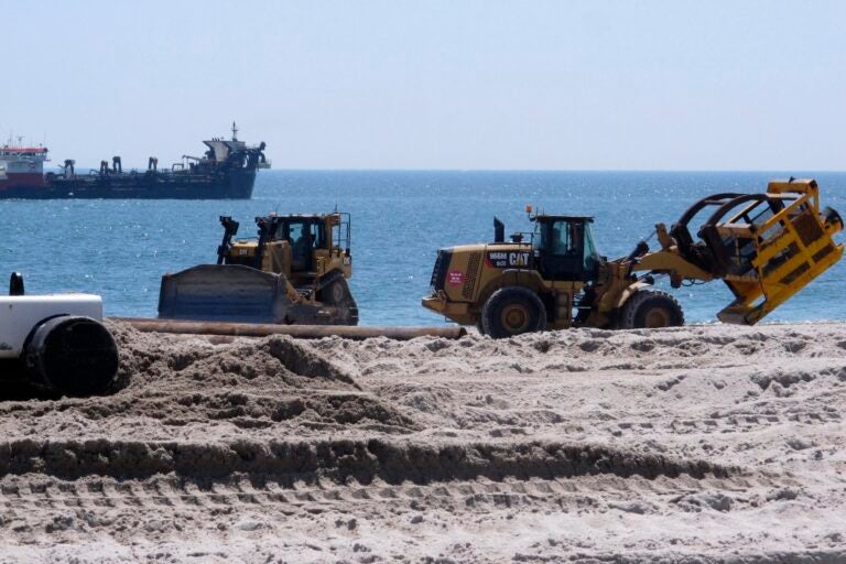 bulldozers on the beach doing replenishment work