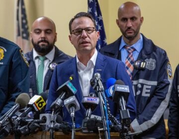 Gov. Josh Shapiro, center, speaks during a press conference regarding the arrest of suspect Luigi Mangione, Monday, Dec. 9, 2024, in Hollidaysburg, Pa., in the fatal shooting of UnitedHealthcare CEO Brian Thompson.