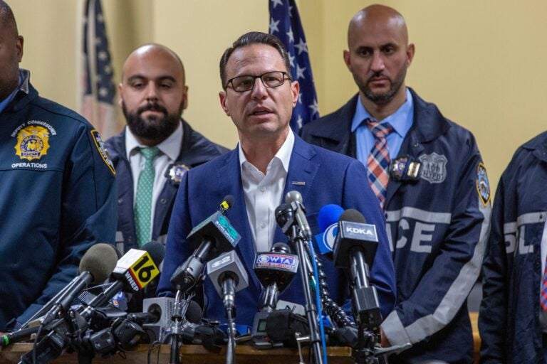 Gov. Josh Shapiro, center, speaks during a press conference regarding the arrest of suspect Luigi Mangione, Monday, Dec. 9, 2024, in Hollidaysburg, Pa., in the fatal shooting of UnitedHealthcare CEO Brian Thompson.