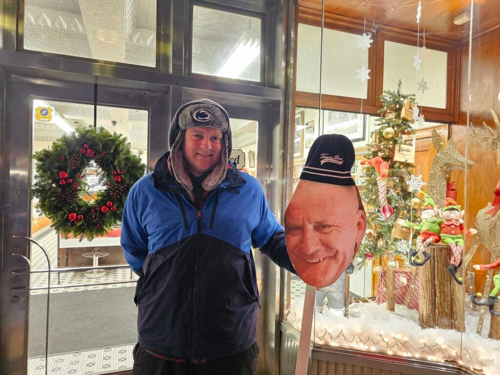 a shopper smiles outside the store