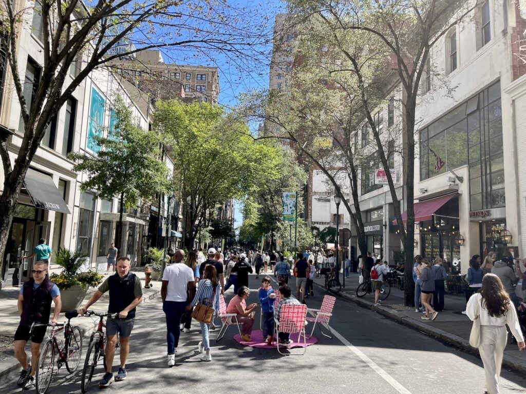 People walk Walnut Street