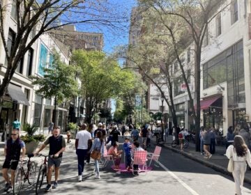 People walk Walnut Street