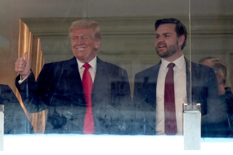 Donald Trump and JD Vance stand and smile