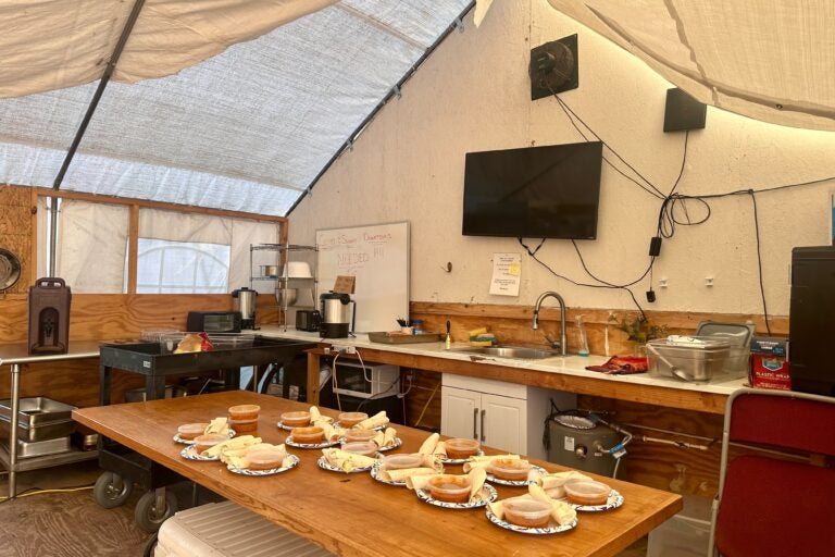 inside the tent is a table with food, among other items