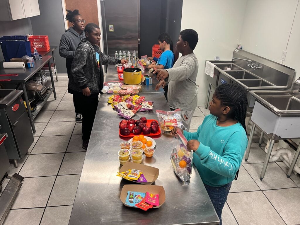 Kids in the kitchen at One Village Alliance