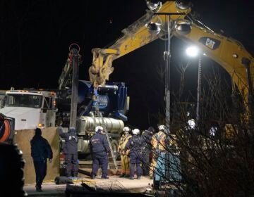 Rescue workers search through the night in a sinkhole for Elizabeth Pollard, who disappeared while looking for her cat, in Marguerite, Pa., Tuesday, Dec. 3, 2024.