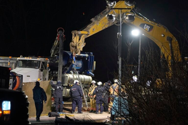 Rescue workers search through the night in a sinkhole for Elizabeth Pollard, who disappeared while looking for her cat, in Marguerite, Pa., Tuesday, Dec. 3, 2024.