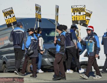 Amazon workers strike outside the gates of an Amazon fulfillment center in City of Industry, Calif., on Thursday