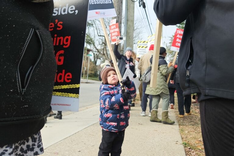 A young boy holding a sign at the protest