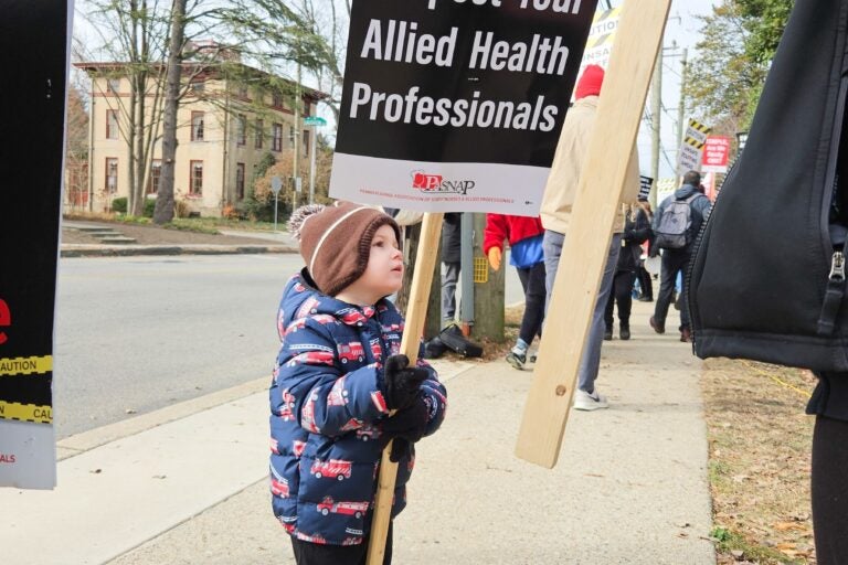 A young boy holding a sign at the protest