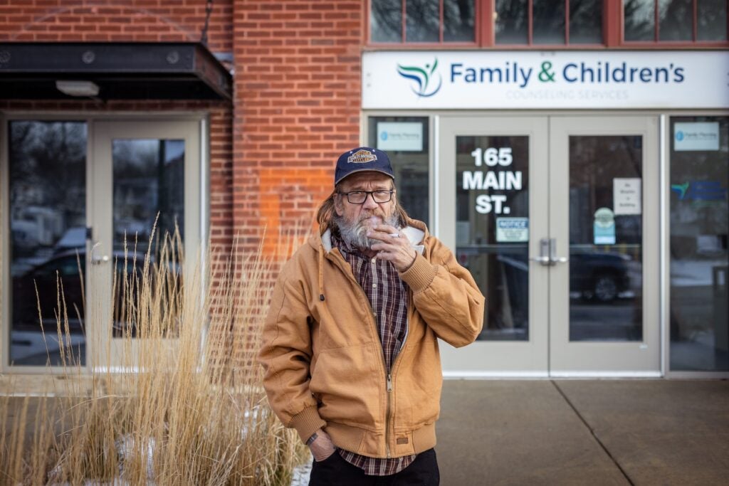 John Greene posing for a photo in front of the clinic