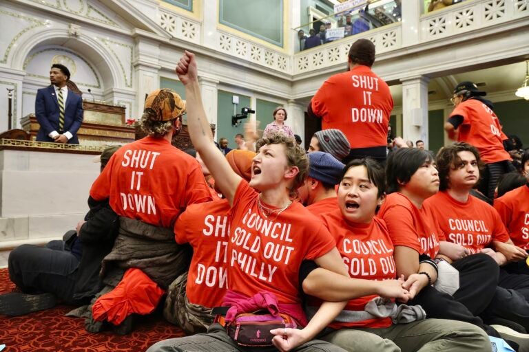 Protesters sitting on the floor and locking arms