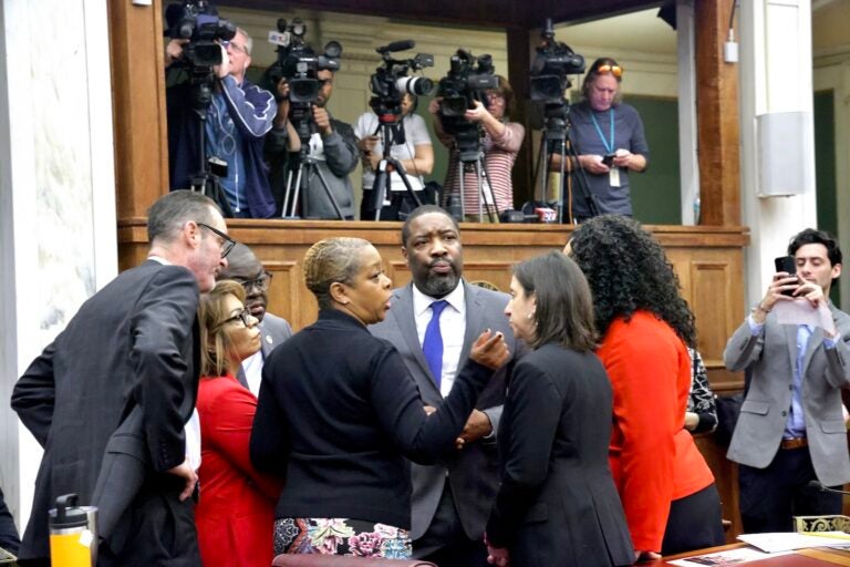 City Council President Kenyatta Johnson confers with council members before a preliminary vote on the Sixers arena proposal