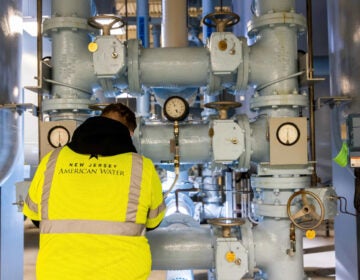 A worker is seen next to a water filtration system