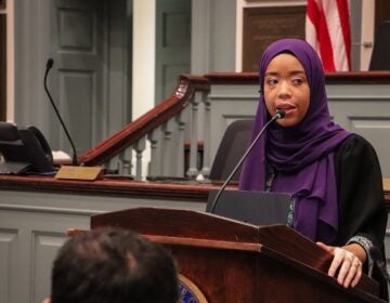 Madinah Wilson-Anton speaking at a podium