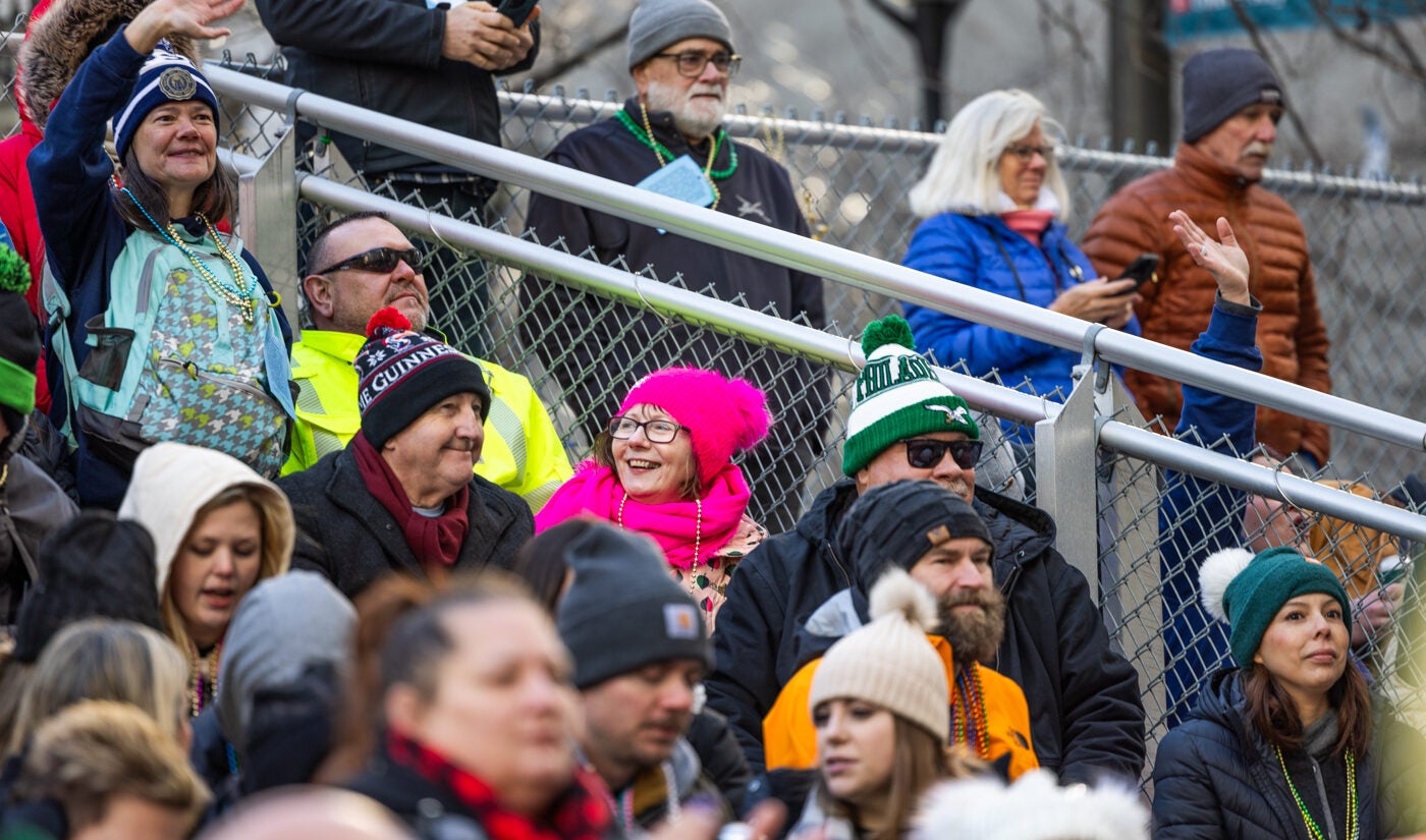 Mummers Parade spectators wave to performers