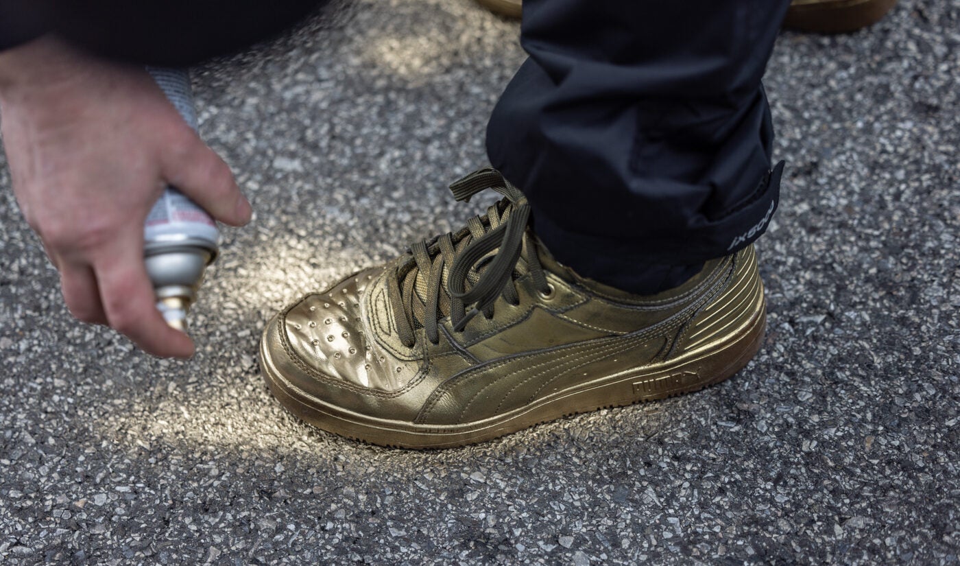 Mummers spray paint their shoes gold