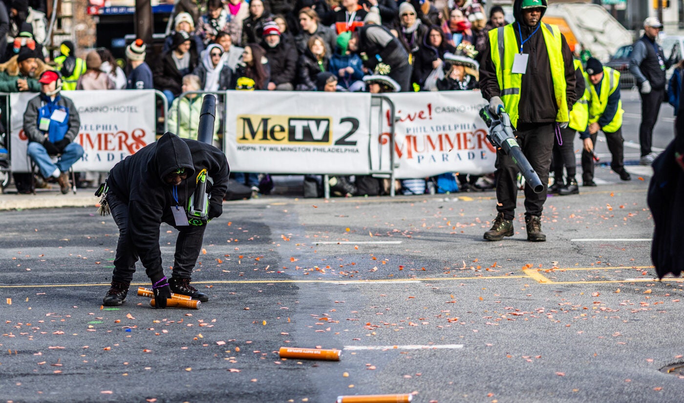 Parade workers move confetti