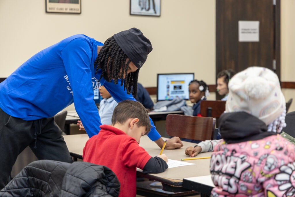 a counselor helps a child with homework