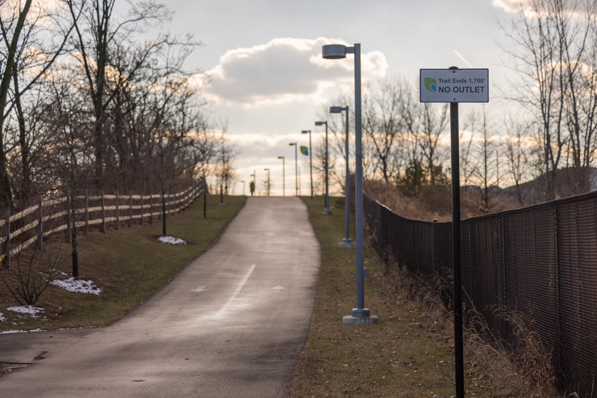 a person in the distance walking on the Schuylkill River Trail