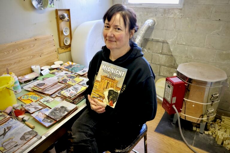 Anne Koszalka holding up a book