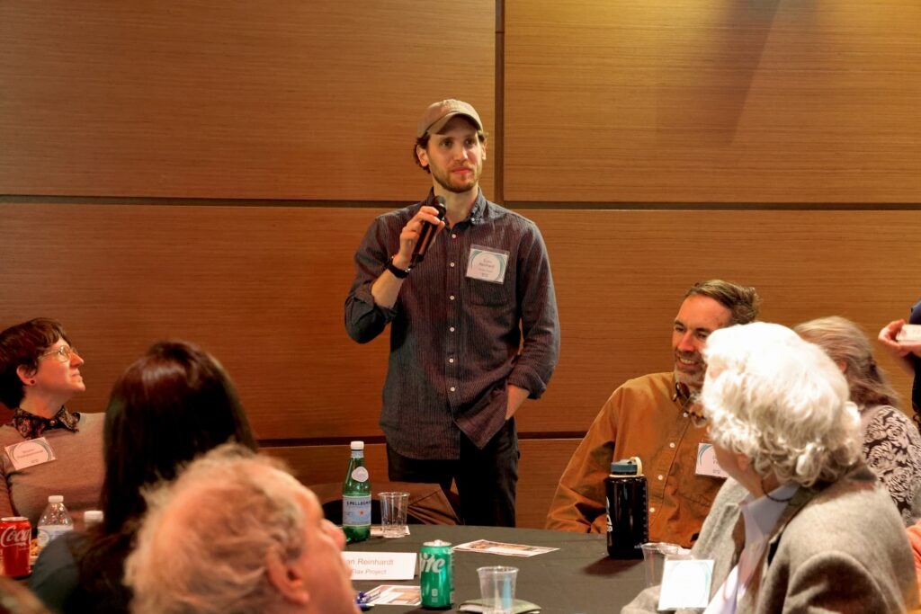 Evan Reinhardt stands and speaks