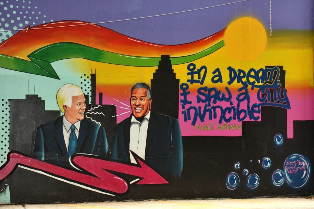 A mural featuring George Norcross and Vic Carstarphen