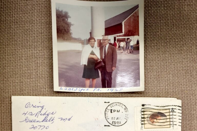 A Sheryl Oring's grandmother and a man in a photo above an envelope