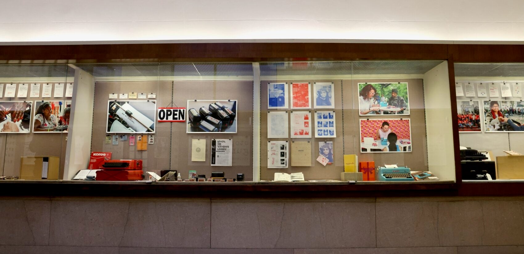 Photos and typewriters are shown in a display