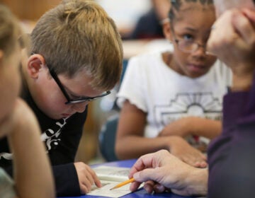 Dylan Mayes, left, reads from a book about Willie Mays during a reading circle in class on Thursday, Oct. 20, 2022, in Niagara Falls, N.Y. (AP Photo/Joshua Bessex)