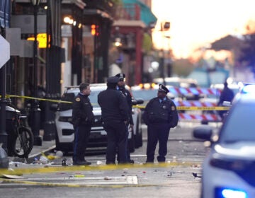 Emergency services attend the scene on Bourbon Street after a vehicle drove into a crowd on New Orleans' Canal and Bourbon Street, Wednesday Jan. 1, 2025. (AP Photo/Gerald Herbert)