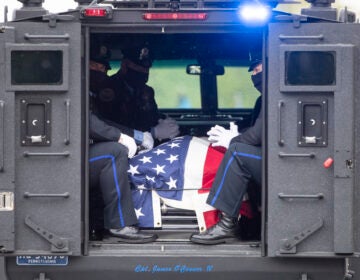 FILE - Police officers wearing a protective face masks as a precaution against the coronavirus accompany the remains of Cpl. James O'Connor as they depart from Our Lady of Calvary Church in Philadelphia, Friday, May 8, 2020. O'Çonnor was shot and killed early Friday, March 13, as he served a homicide warrant at a home in the Philadelphia's Frankford section. (AP Photo/Matt Rourke, File)