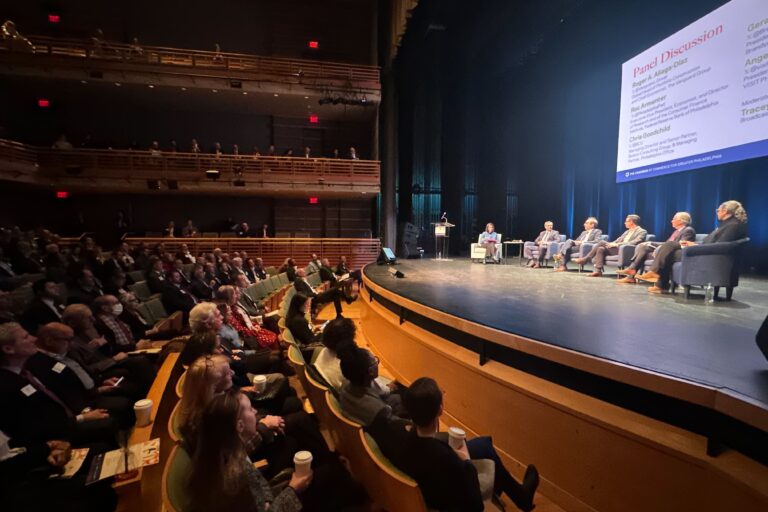 people watch a panel discussion