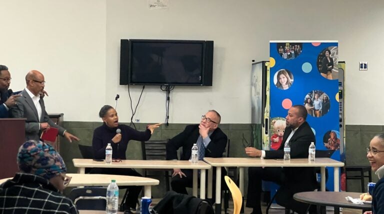 Panelists sitting at a table during a conversation