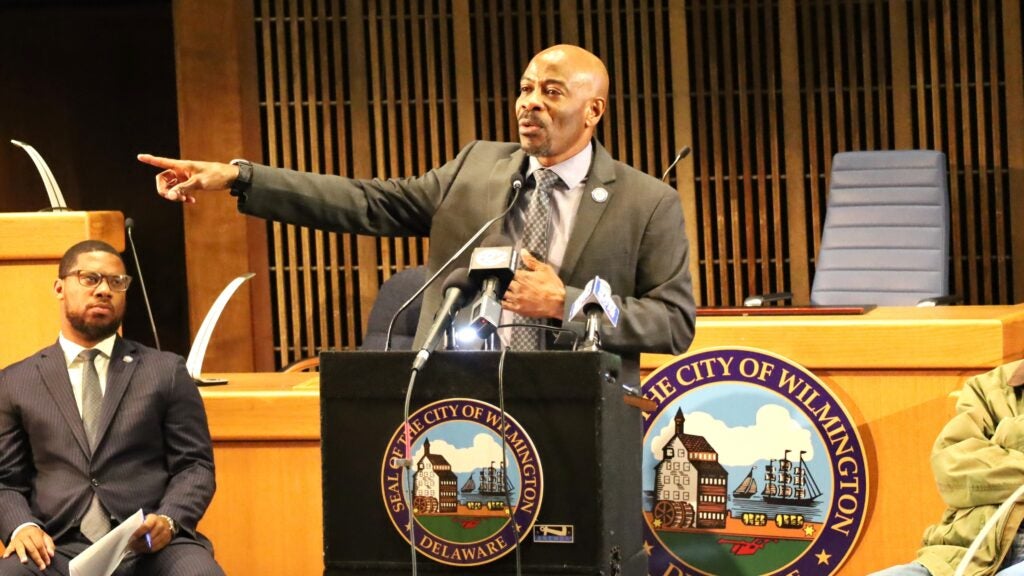 Nnamdi Chukwuocha speaks behind a podium