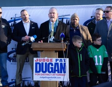 Pat Dugan speaks behind a podium