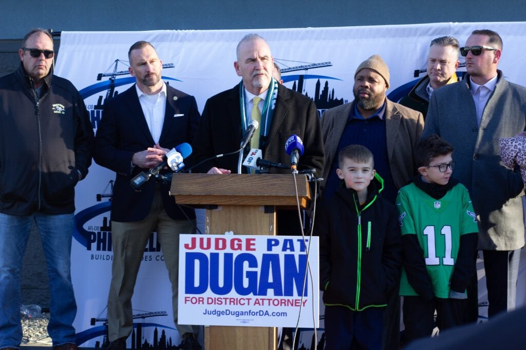 Pat Dugan speaks behind a podium