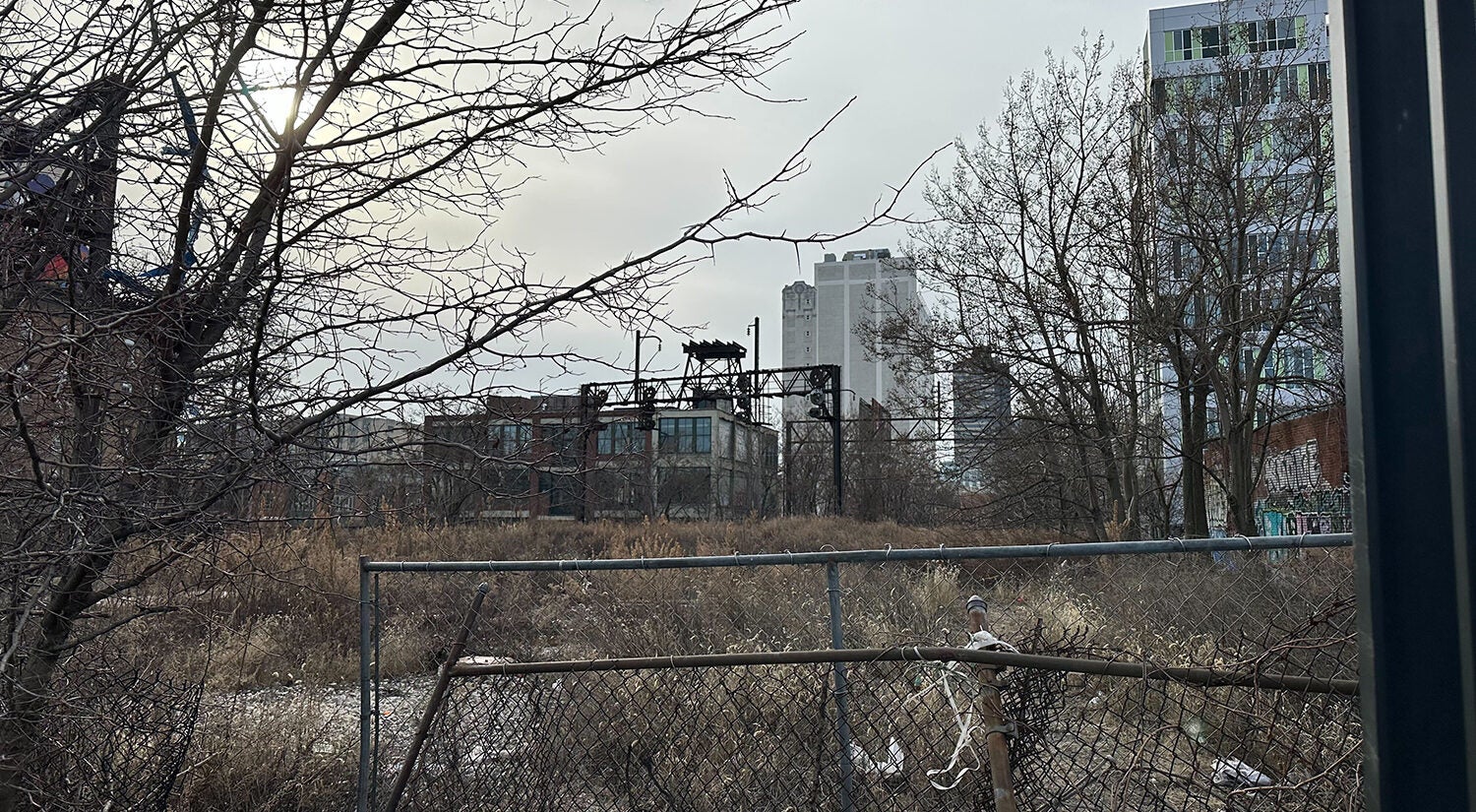 Just outside the iron gates there's a clear view of the undeveloped train trestle through the wire fence. (Kristen Mosbrucker-Garza/WHYY)